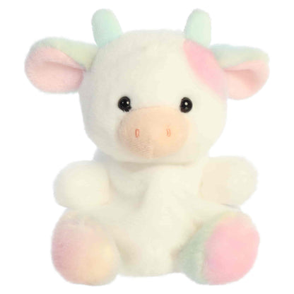 Head-on front seated view of Aurora Palm Pals Georgia Rainbow Cow plush showing pink muzzle, horns, and pastel hooves.