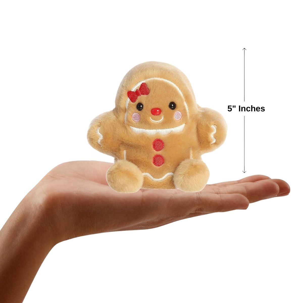 Aurora Palm Pals 5-inch Gia Gingerbread Girl plush resting in an open hand with height measurement graphic.