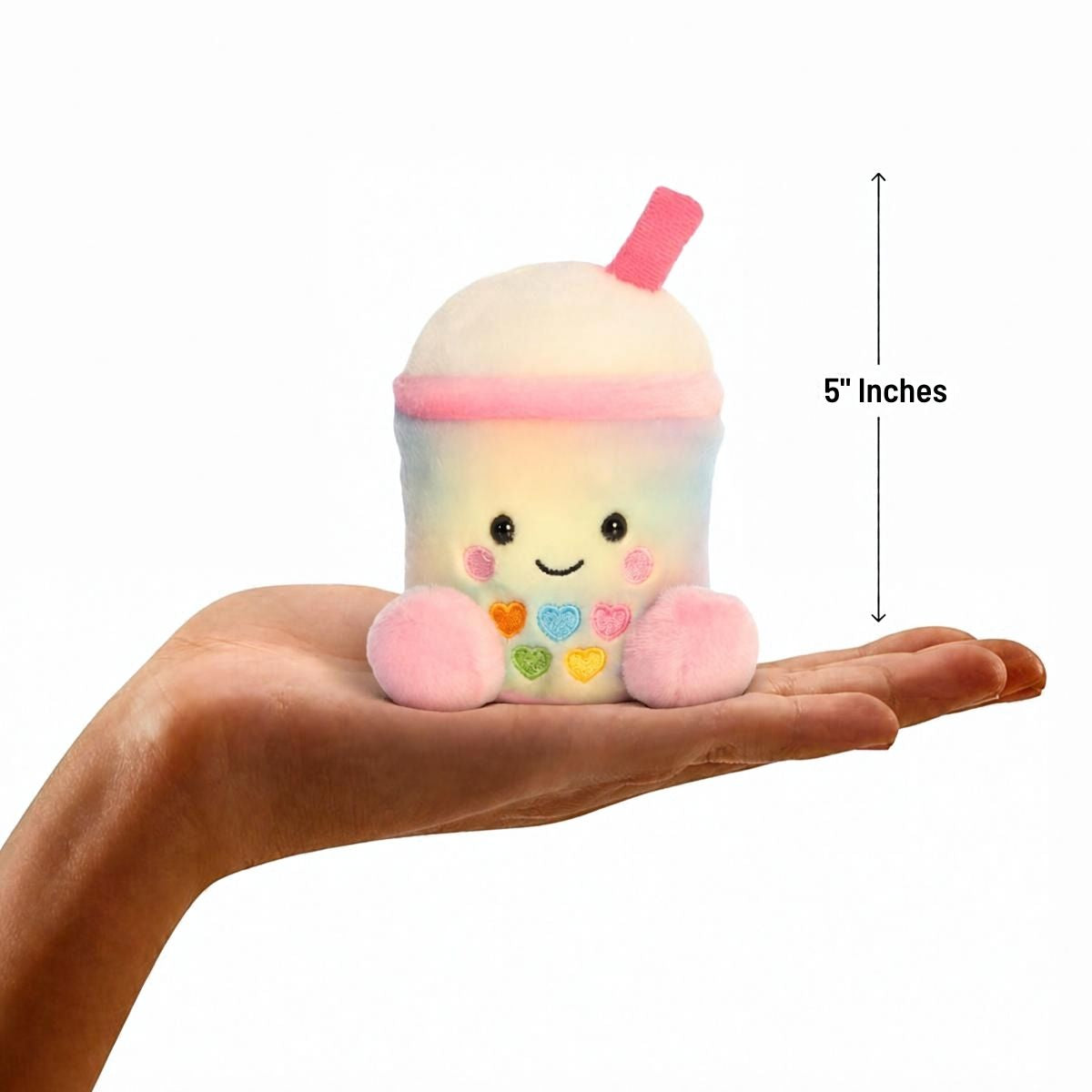 Aurora Palm Pals 5-inch Isa Rainbow Boba plush resting in the palm of an open hand.