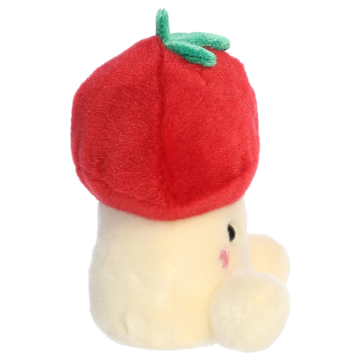 Side profile view of Aurora Palm Pals Lucy Strawberry Mushroom plush showing rounded red cap and stalk body.