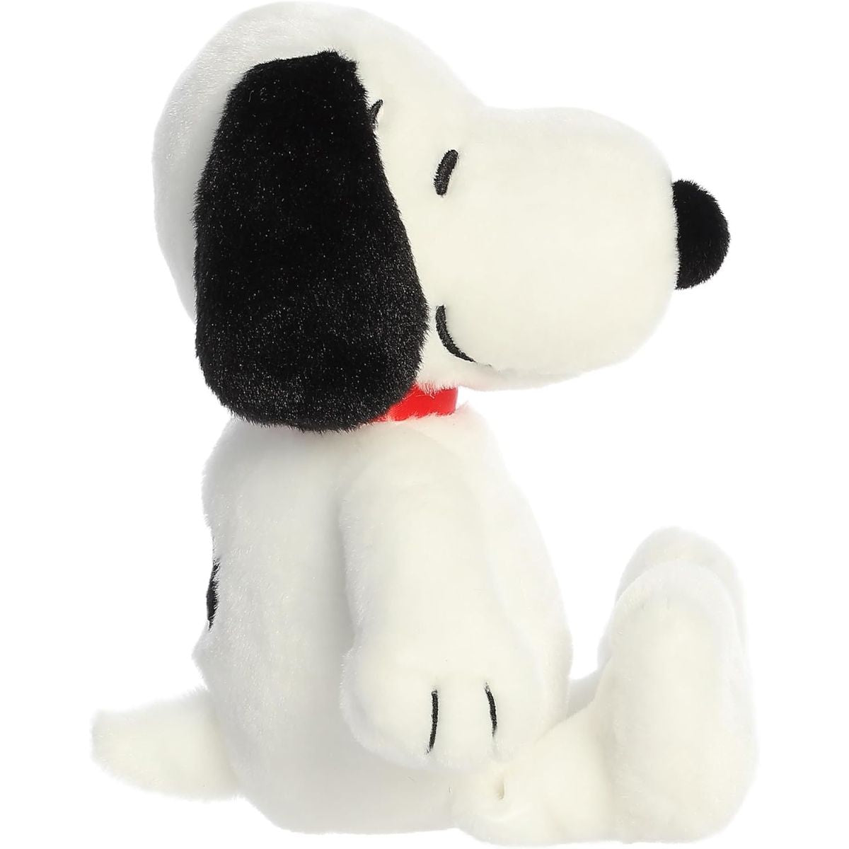 Side profile view of the white Snoopy plush highlighting his floppy black ears and sitting pose.