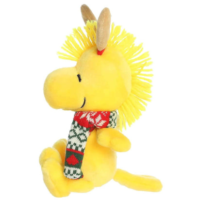 Left side profile view of Aurora Peanuts Reindeer Woodstock plush showing yellow head crest and seated posture.