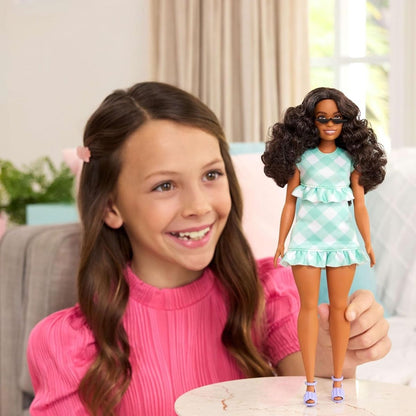 Lifestyle thumbnail showing a girl playing with Barbie Fashionistas Doll #240.