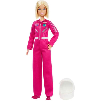 Full-length standing view of 12-inch Barbie Astronaut doll next to her white space helmet on the ground.
