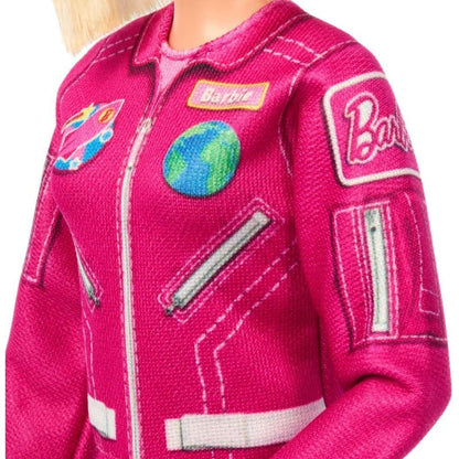 Close-up detail thumbnail of hot pink flight suit chest showing Earth globe and space mission patches.