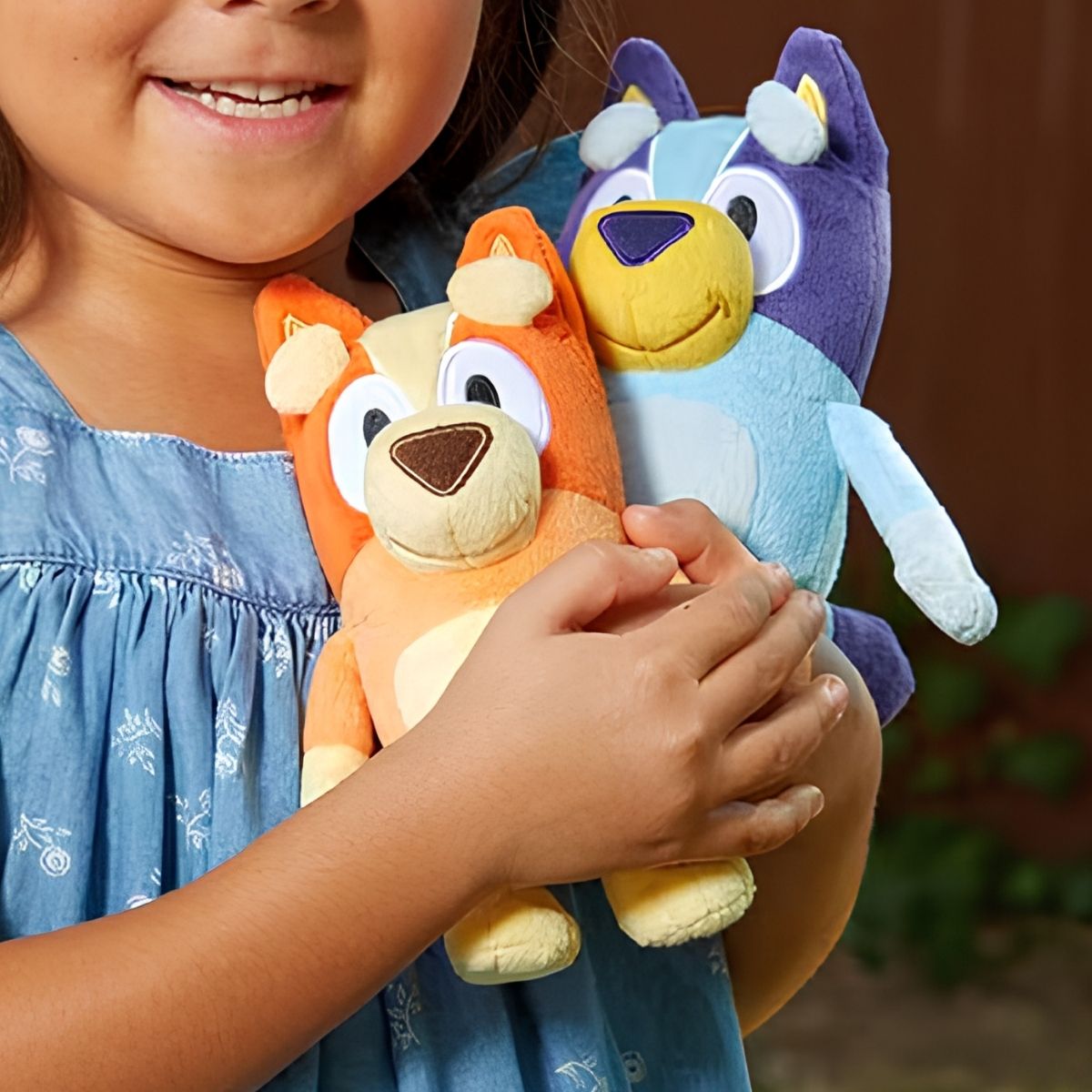 Hand holding Bluey Friends Bingo 7-inch stuffed animal plush standing upright.