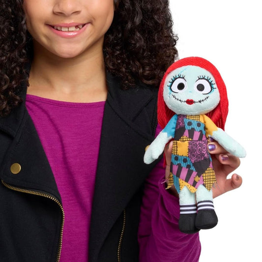 Child holding Disney The Nightmare Before Christmas Sally 8.5-inch plush toy.