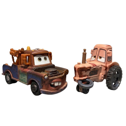Loose view of 1:55 scale die-cast Mater tow truck and Tractor with black tire caught in its mouth.