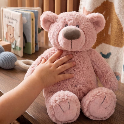 Lifestyle thumbnail showing a child's hand gently touching Happy Horse Bear Brim plush.