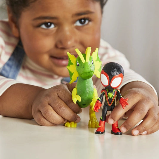 Close-up lifestyle shot of a smiling young child playing with the Miles Morales and Electrosaurus action figures.