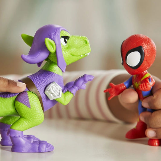 Lifestyle shot of a child making the Spidey and Goblin Raptor toys interact on a playroom table.