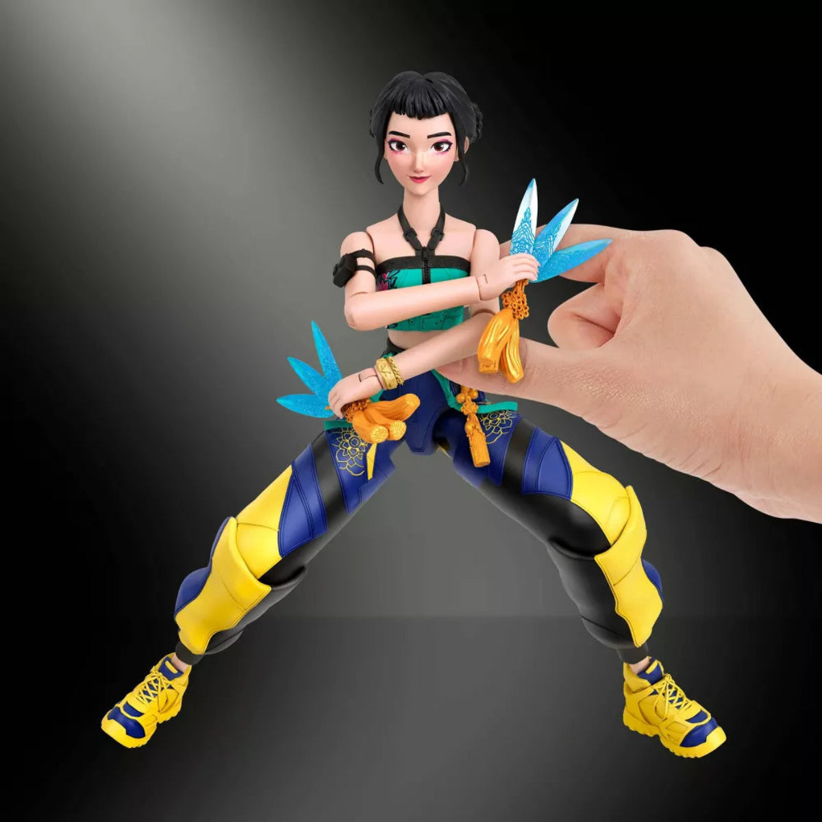 Hand posing Zoey 6-inch action figure holding dual Spirit Blades in a wide stance.