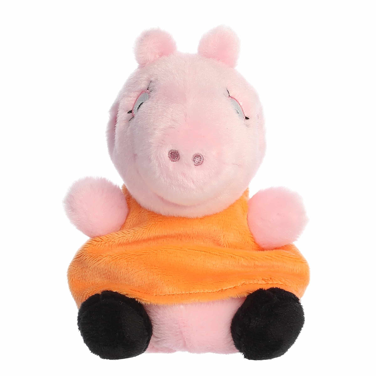 Plush toy pig in an orange outfit on a white background