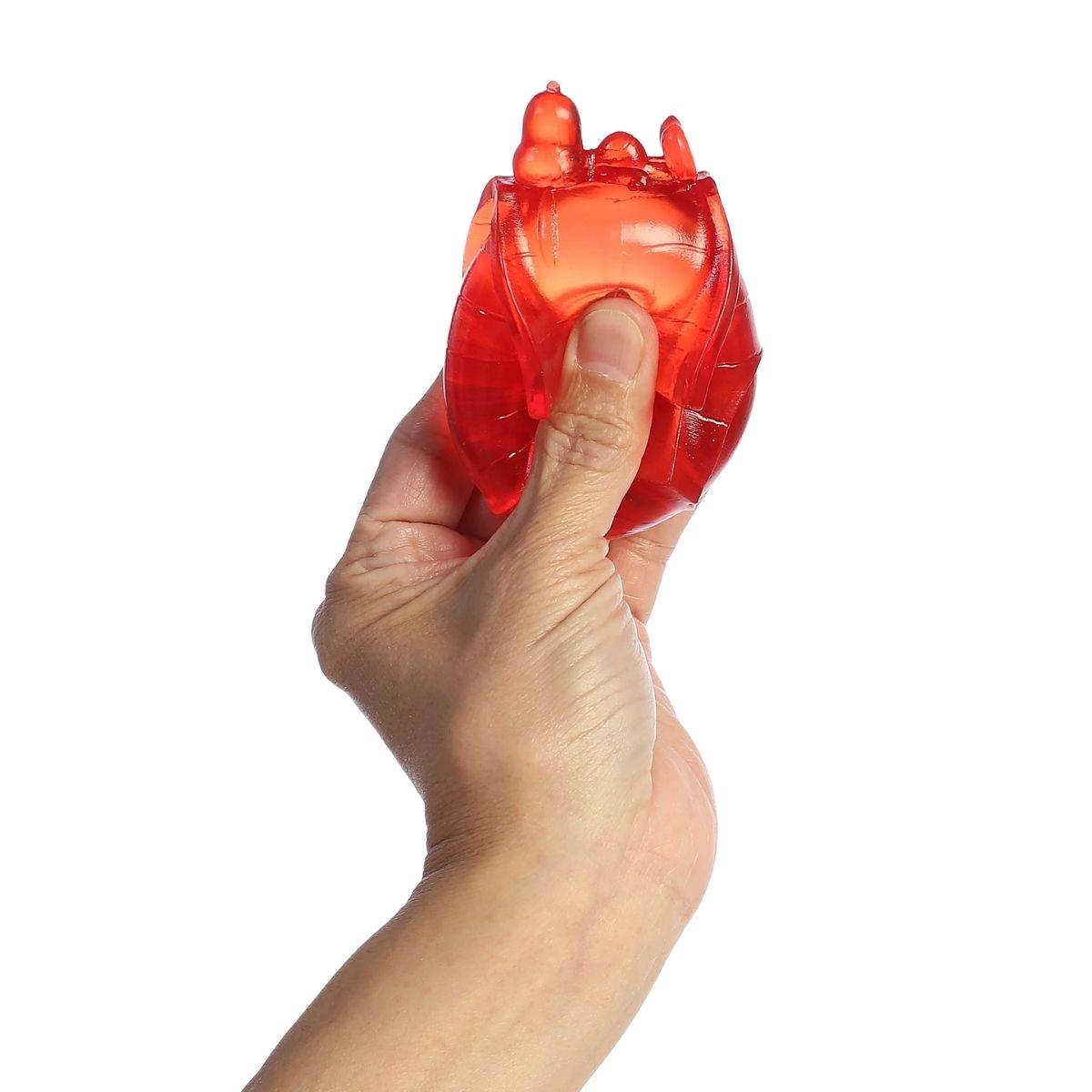 Thumbnail showing a hand squeezing the red translucent sugar squeezy doghouse toy.