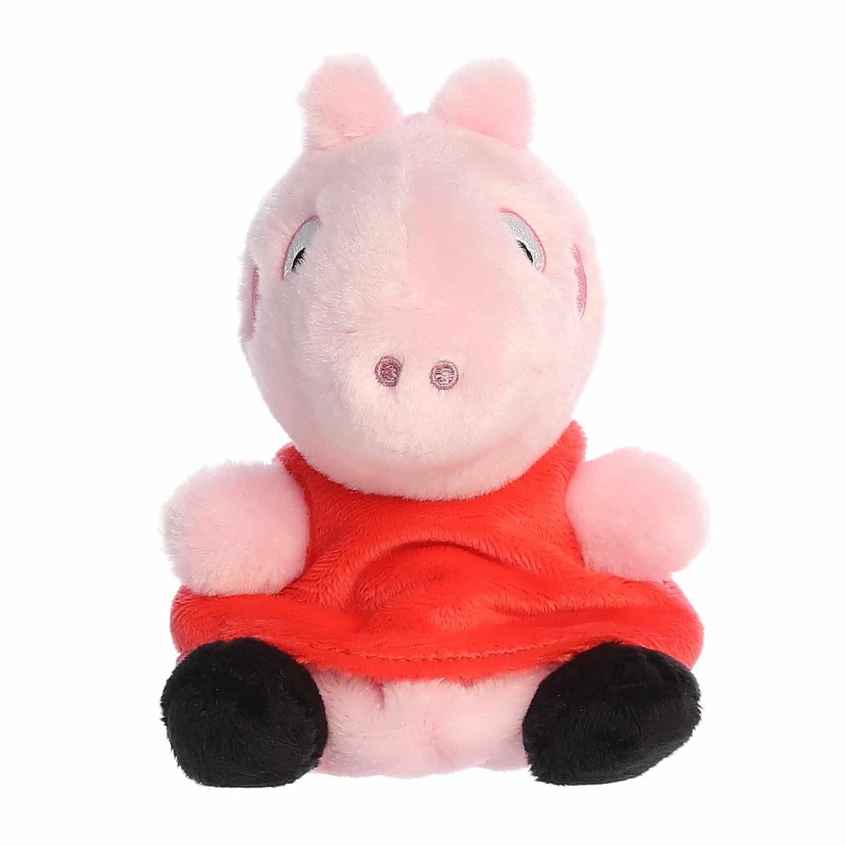 Plush toy pig in a red outfit on a white background
