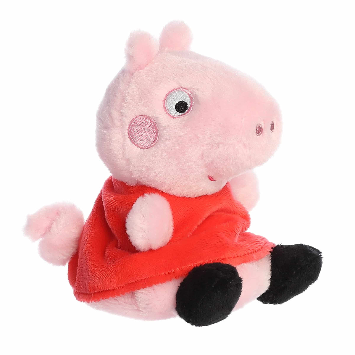 Plush toy of a pink pig character in a red dress on a white background