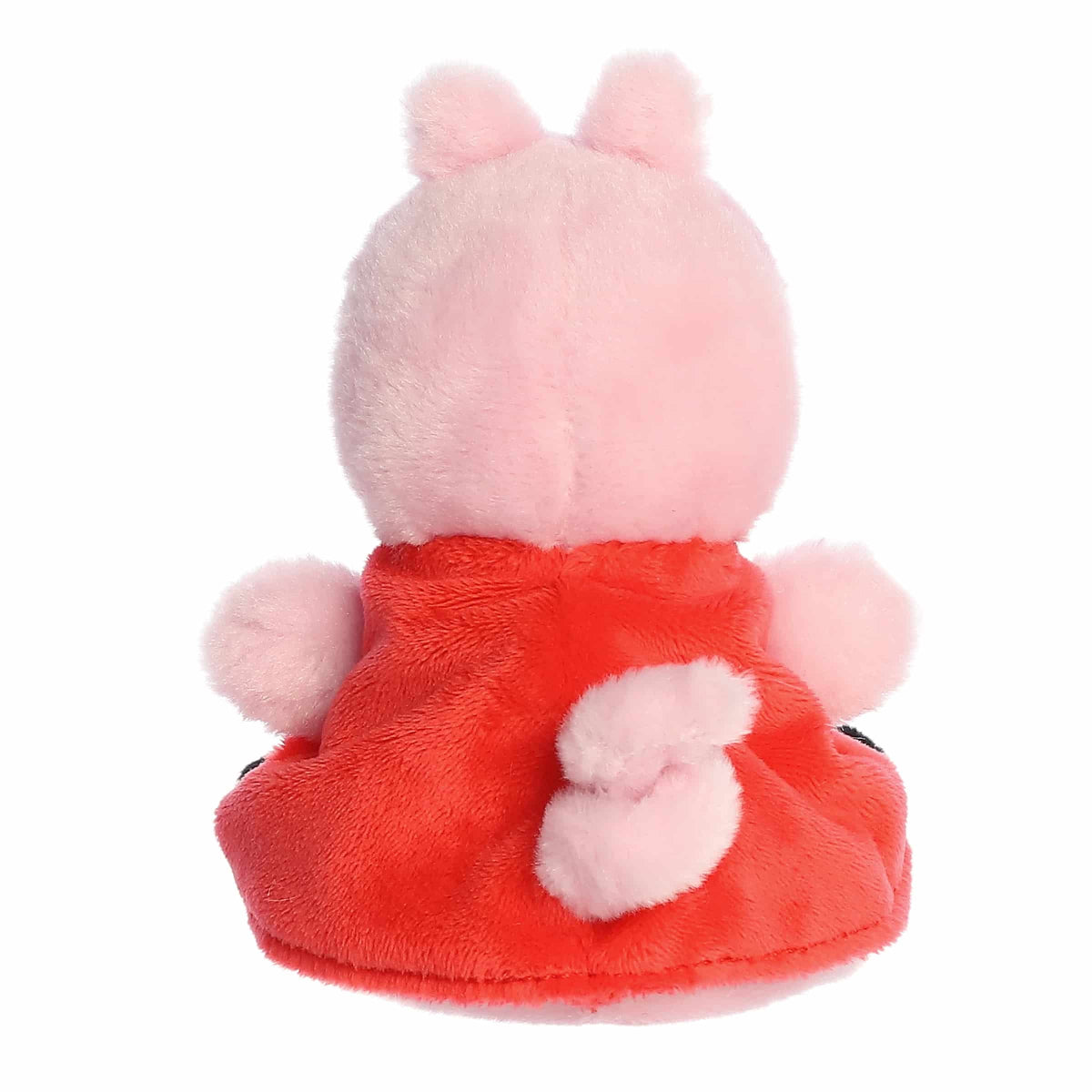 Plush toy with pink fur and red outfit on a white background