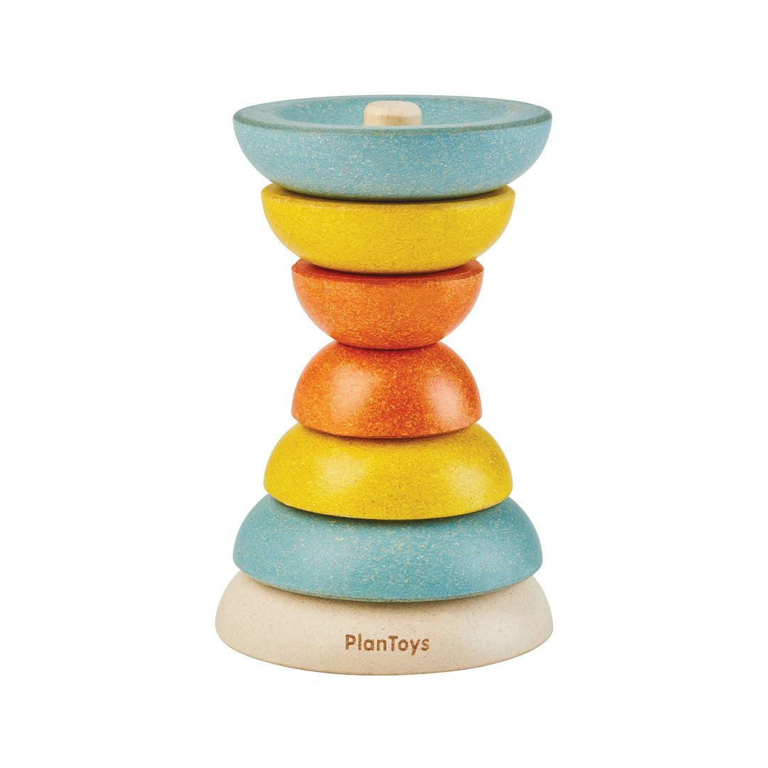 PlanToys wooden stacking cups arranged in an hourglass tower configuration.