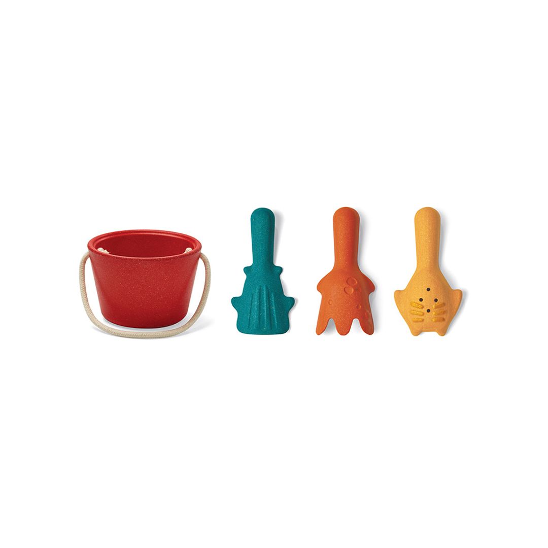 Product lineup of the PlanToys red sand bucket next to the teal, orange, and yellow tools on a white background.
