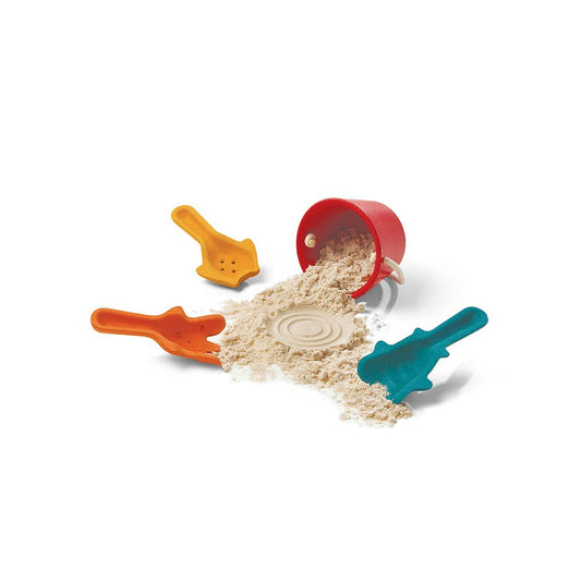 PlanToys wooden 4-piece sand and bucket play set spilling on sand with red bucket, teal, orange, and yellow tools.