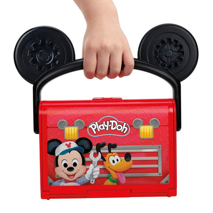 Close-up thumbnail of a child holding the closed red Mickey Mouse Clubhouse garage carrying case by its black ear handle.