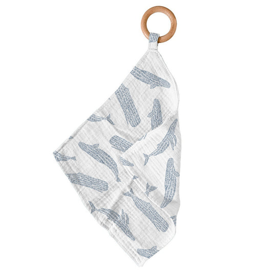 Newcastle Classics Blue Shadow Whales bamboo muslin blankie teether hanging from its smooth natural wood ring.