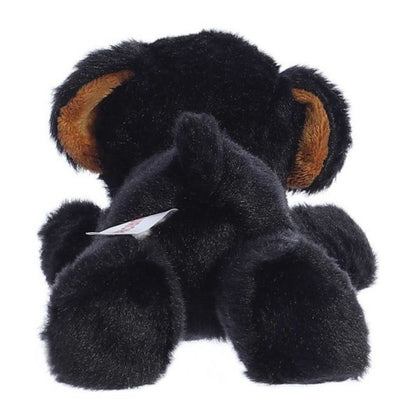 Rear view of the black Rottweiler plush showing its soft back, hind paws, and a small stubby tail.