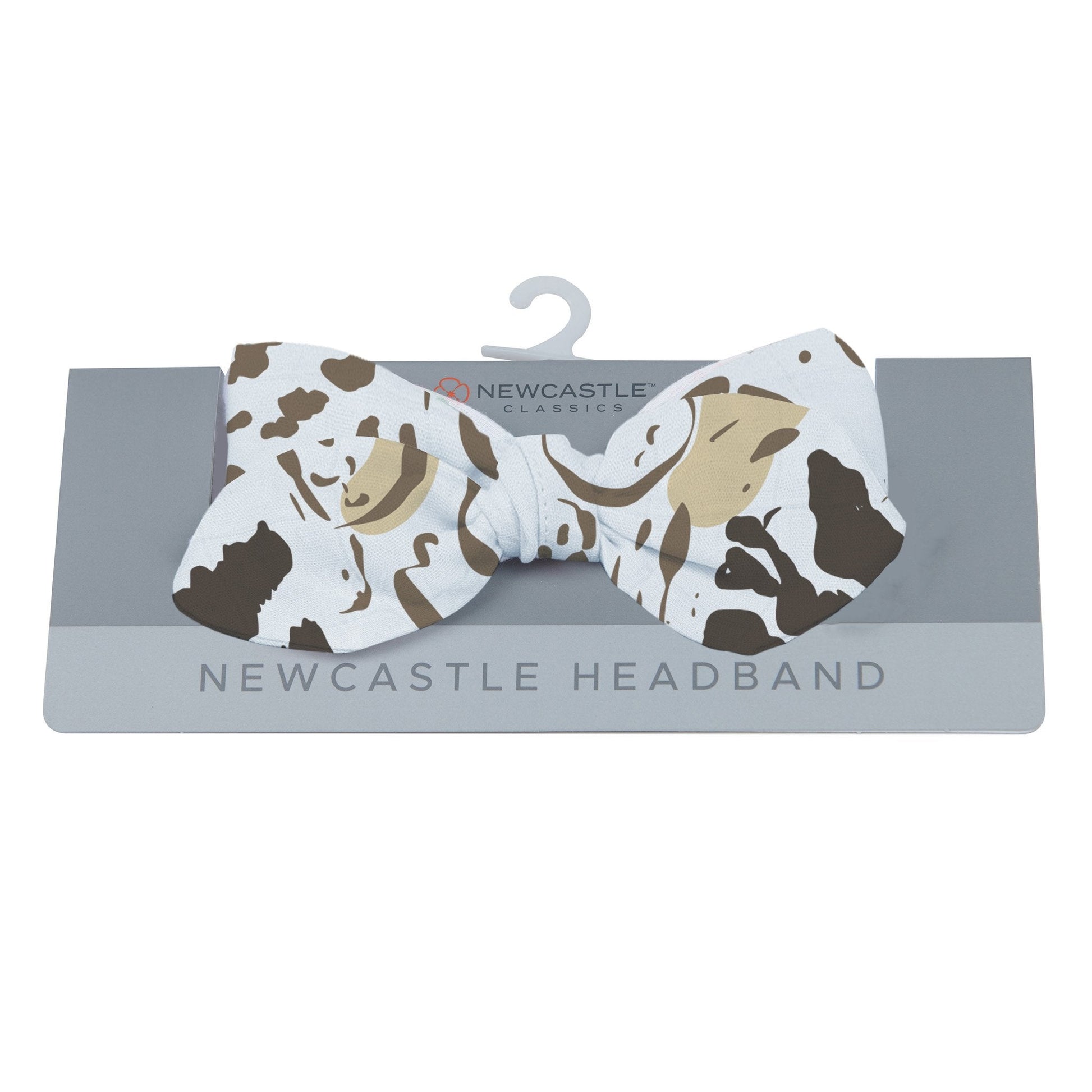 Newcastle Classics animal print baby headband displayed on its grey retail hanging card.