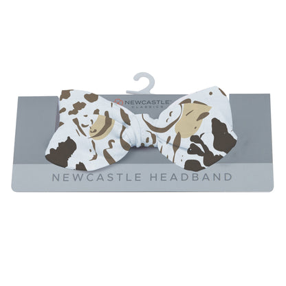 Newcastle Classics animal print baby headband displayed on its grey retail hanging card.