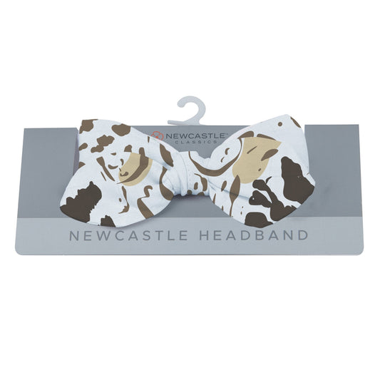 Newcastle Classics animal print baby headband displayed on its grey retail hanging card.