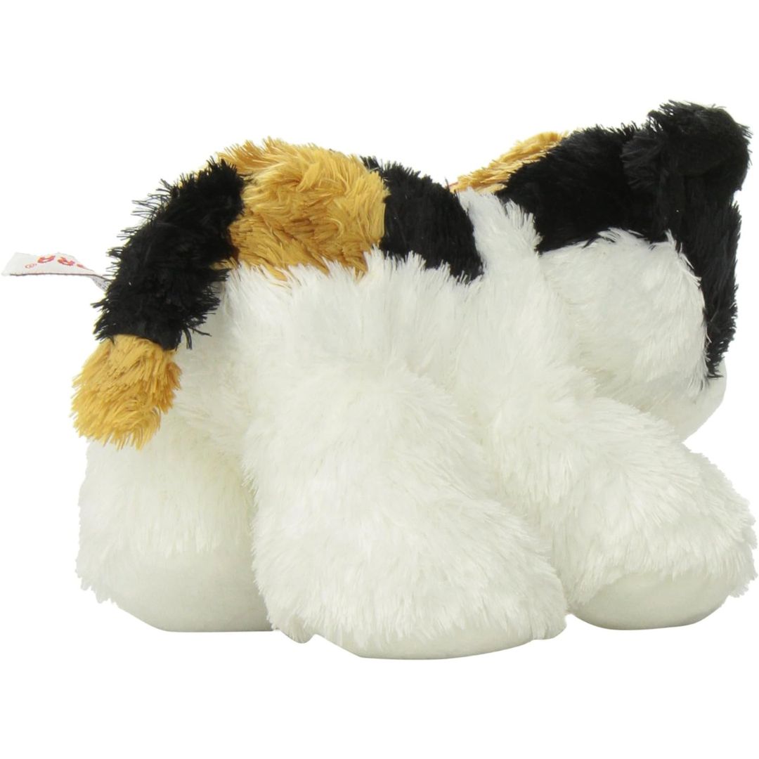 Rear view of the calico kitten plush showing its patched back, white hind legs, and long outstretched black, white, and orange tail.