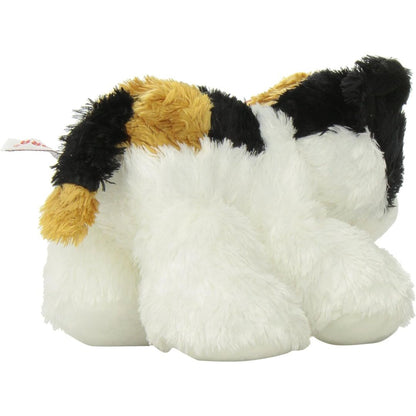 Rear view of the calico kitten plush showing its patched back, white hind legs, and long outstretched black, white, and orange tail.