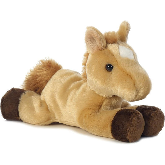 Angled side view of the Aurora Mini Flopsie Prancer Horse 8-inch plush resting on its belly, featuring light tan fur, a brown mane, and a white forehead star.
