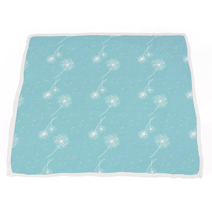 The multi-layer muslin blanket fully laid out to display the black and white Corgi dog print with an aqua blue corner fold.