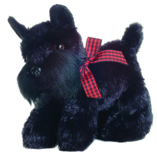 Angled view of the Aurora Mini Flopsie 8-inch Scotty the Scottish Terrier plush sitting upright, showing its black fur and red plaid bow.