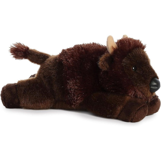 Angled side view of the Aurora Mini Flopsie Plains Buffalo 8-inch plush resting on its belly, featuring shaggy dark brown fur and small tan horns.