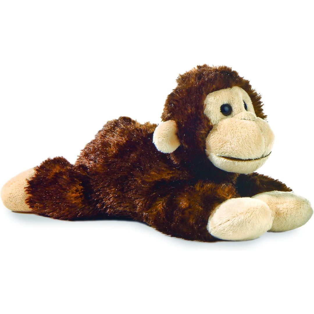 Angled side view of the Aurora Mini Flopsie Cheki Chimp 8-inch plush resting on its belly, featuring dark brown fur and tan hands.