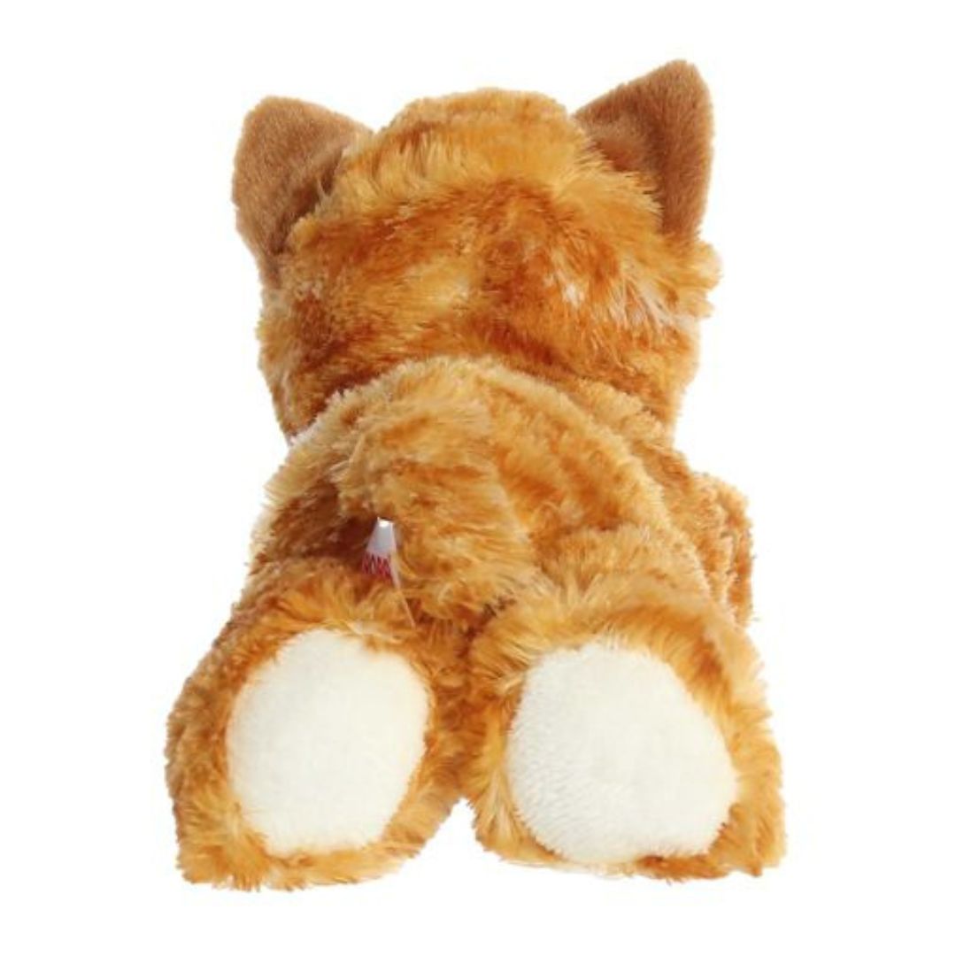 Rear view of the orange cat plush showing its striped back, white hind paws, and a long outstretched tabby tail.