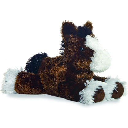 Angled side view of the Aurora Mini Flopsie Clydes Clydesdale Horse 8-inch plush resting on its belly, featuring brown fur and white feathered hooves.