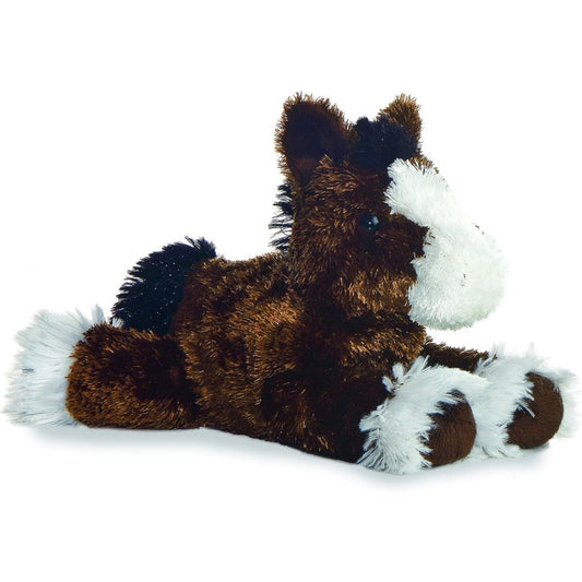 Angled side view of the Aurora Mini Flopsie Clydes Clydesdale Horse 8-inch plush resting on its belly, featuring brown fur and white feathered hooves.
