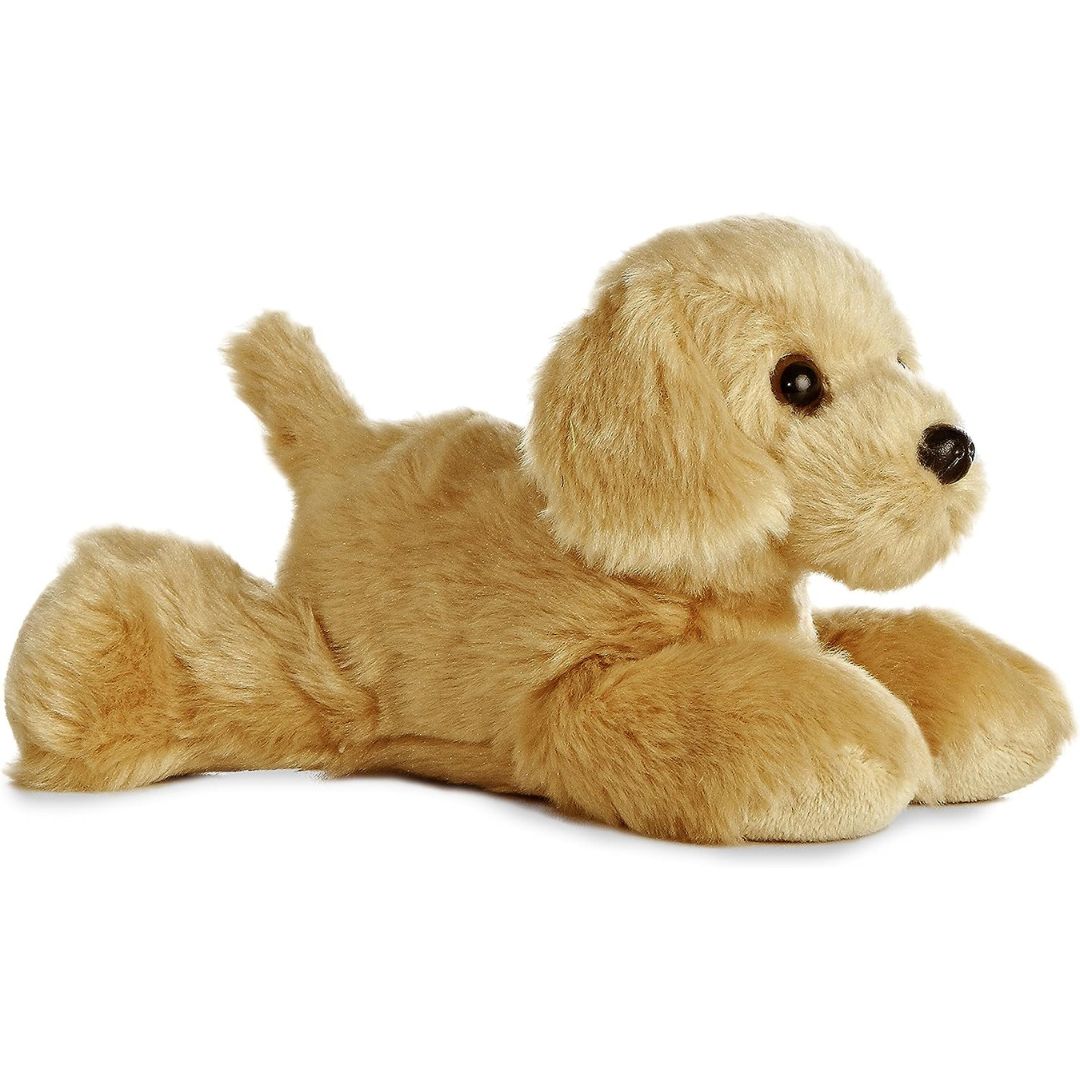 Angled front view of the 8-inch Aurora Mini Flopsie Golden Yellow Labrador stuffed animal resting on its tummy, showing its soft golden-tan coat and floppy ears.