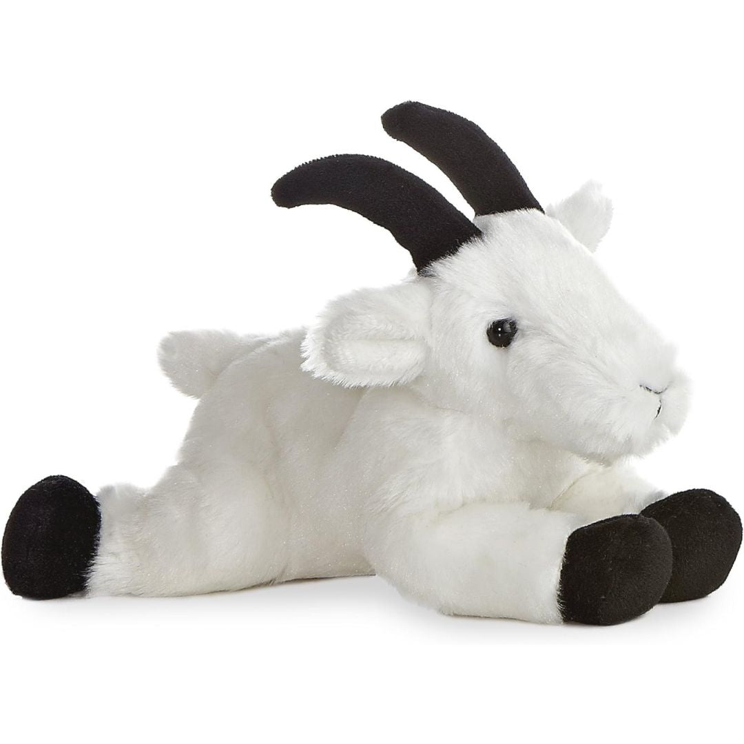 Angled front view of the 8-inch Aurora Mini Flopsie Rocky Mountain Goat stuffed animal lying down with white fur and black horns.