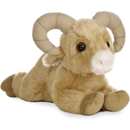 Angled side view of the Aurora Mini Flopsie Bighorn Sheep 8-inch plush resting on its belly, featuring sandy-tan fur and large curved horns.