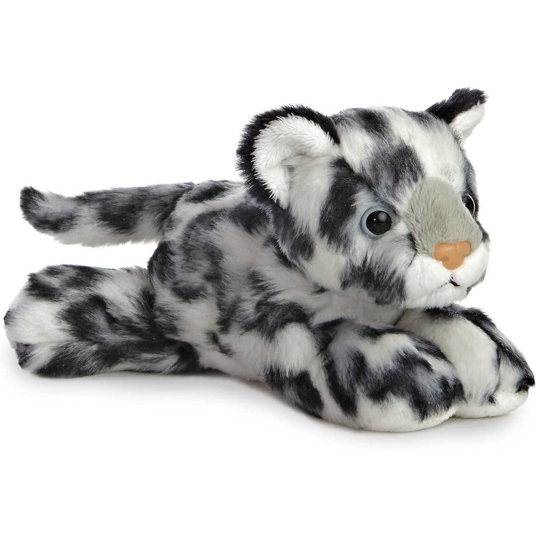 Angled side view of the Aurora Mini Flopsie Snow Leopard 8-inch plush resting on its belly, featuring grey and white fur with black spots.