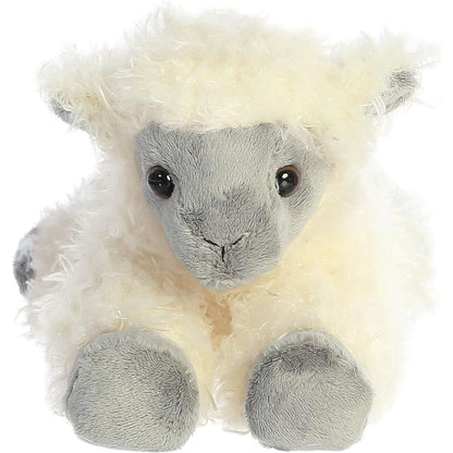 Direct front view of the soft Aurora plush sheep lying down, highlighting its dark face and sweet eyes.