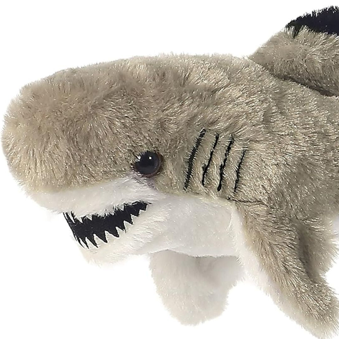 Close-up view of the soft shark plush highlighting its toothy smile, dark eye, and black stitched side gills.