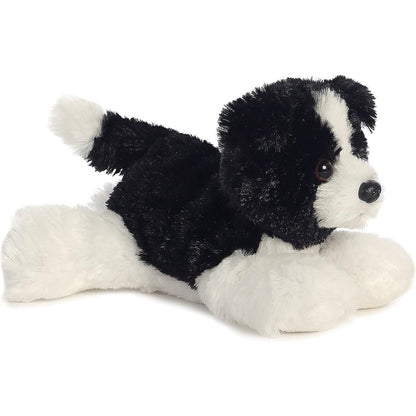 Angled side view of the Aurora Mini Flopsie Cami Border Collie 8-inch plush resting on its belly, featuring black and white fur.
