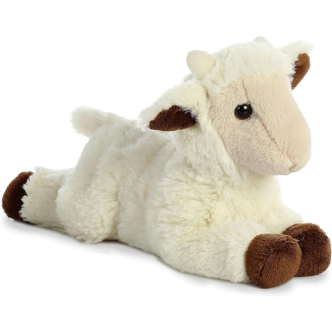 Angled side view of the Aurora Mini Flopsie Goat Kid 8-inch plush resting on its belly, featuring fluffy cream fur and brown hooves.