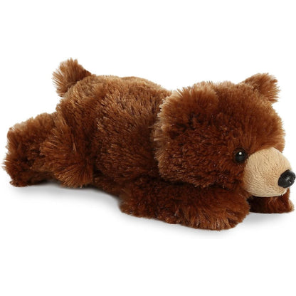Angled front view of the 8-inch Aurora Mini Flopsie Grizzly Bear stuffed animal lying down, showing its fluffy brown fur and tan snout.