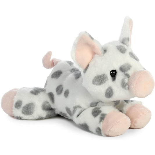 Angled view of the Aurora Mini Flopsie 8-inch Spotted Piglet plush resting on its belly, showing its white and grey spotted fur and pink snout.